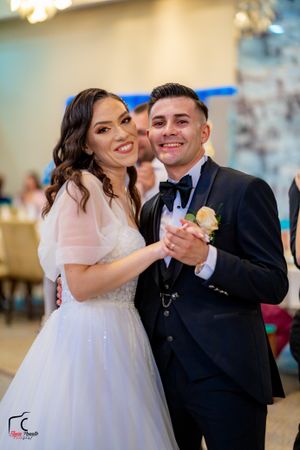 Joyful dancing at wedding reception with elegant decor and ambient lighting.
