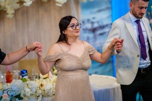 Formal event guests enjoying themselves at a beautifully decorated venue.