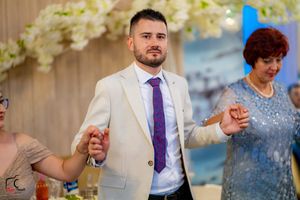 Celebration at an upscale venue with guests dancing under ambient lighting.