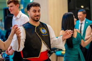 Dancers in traditional folk costumes perform traditional dances at a celebration.