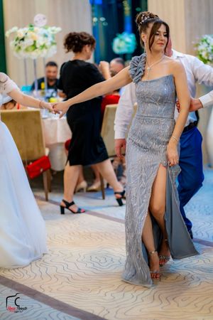 Dancers in elegant evening wear perform choreographed moves at a formal celebration.