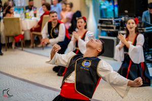 Performers execute synchronized dance moves during a wedding reception.