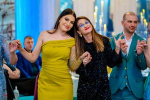Celebratory scene at a wedding reception with guests in formal attire and festive atmosphere.