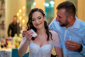 Wedding reception dance floor filled with joyful couples dancing together under warm lighting.