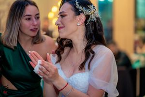 Elegant wedding reception dance scene with couples swaying to music in a beautifully lit venue.