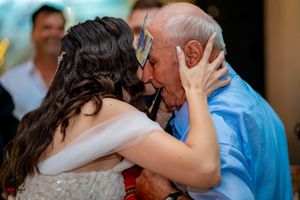Couples dancing together during an intimate moment at an elegant wedding reception.