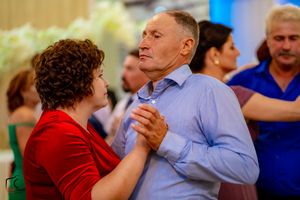 Couples dancing together at an elegant wedding reception with colorful formal attire.