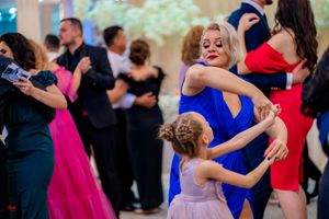 Wedding guests dancing and enjoying themselves on a crowded dance floor at a reception.