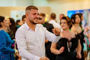 Guests enjoying themselves on a crowded dance floor at an indoor celebration.