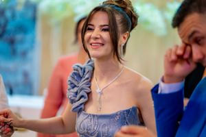 Elegant formal event with guests in dressy attire dancing under soft lighting.