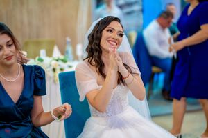 Wedding guests dance and celebrate together at a joyful reception party.