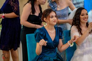 Wedding party members dance in sync during a choreographed reception performance.