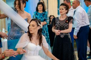 Wedding celebration features coordinated group dance routine with guests in formal attire.