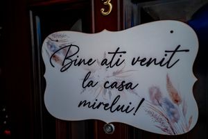 Decorative welcome signs in Romanian language displayed at a wedding venue.