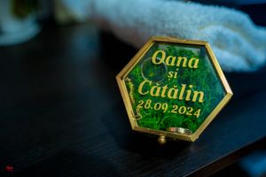 Close-up of green and gold hexagonal wedding name plates with date engraving.