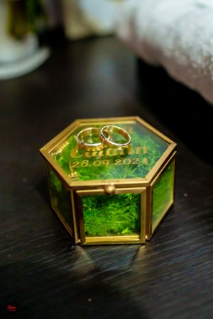 Detailed shot of decorative hexagonal glass boxes with gold trim and green interior.