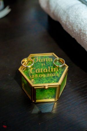 Custom wedding ring boxes with names and date in emerald green and gold design.
