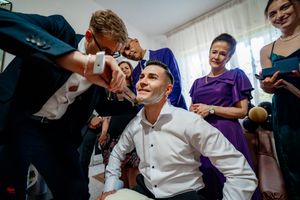 Celebratory moment captured during an indoor party game with guests in formal attire.