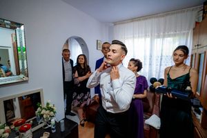 Guests and wedding party members share a lighthearted moment during pre-ceremony festivities.
