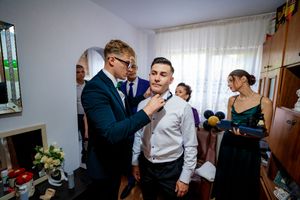 Wedding guests and party members engage in celebratory activities in a home environment.