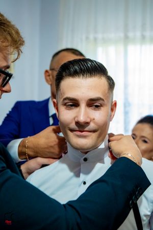 Final touches being made to formal wear during intimate pre-wedding preparations.
