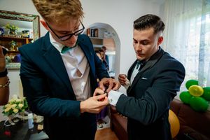Formal event preparation showing people in suits and bowties getting ready.