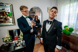 Wedding preparation scene with formal attire and decorative balloons.