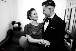 A pair sharing an elegant dance moment in a warmly lit room.