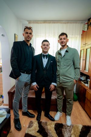 Small group stands together for a photo in a wood-paneled room.