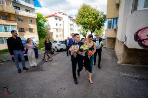 Guests mingling outside an apartment building during a celebration.