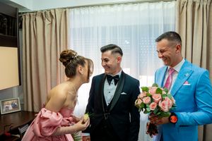 A special moment captured during wedding preparations in a room with beige curtains.