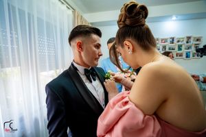 An intimate pre-wedding scene with soft natural lighting and beige curtains.