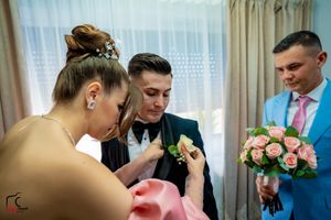 Wedding preparation scene with pink roses and light blue suit details.