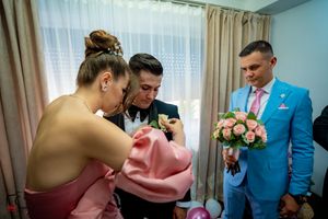 Pre-wedding preparations in a room with natural lighting and elegant decor.