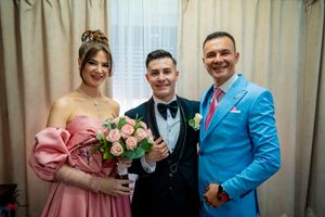Celebration group poses in formal wear with pink and blue color coordination.