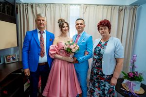 Family group photo with coordinated formal wear in blue and pink tones.
