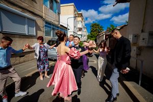 Energetic dance sequence captured in panoramic view on a residential street.