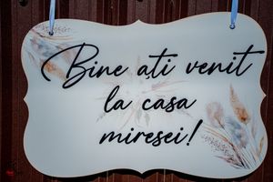 Decorative wedding welcome sign with elegant script text and floral designs.