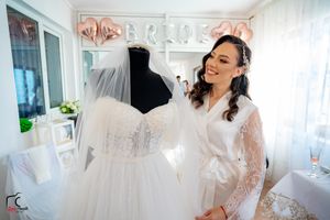 Bright white bridal boutique interior with wedding gowns on display.