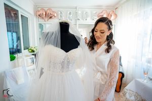 Wedding dress showroom with elegant white gowns and decorative elements.