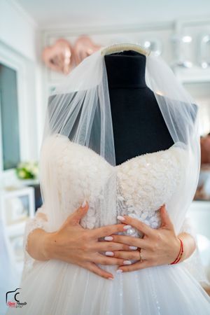 Close-up of intricate lace details on a white wedding dress bodice.