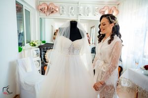 Bridal boutique interior with white wedding gowns and festive decorations.