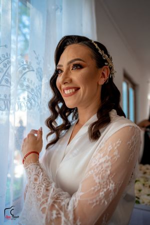A delicate lace sleeve wedding gown is captured in soft window light.