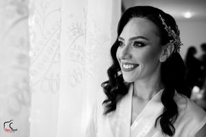Black and white portrait showcases intricate wedding day details and soft lighting.