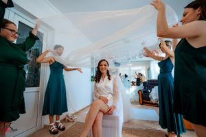 Candid moments during wedding preparations showing attendants in navy blue dresses.