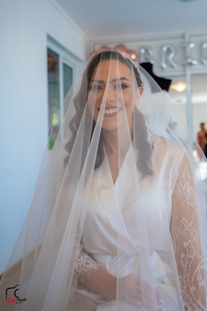 Close-up shots of bride wearing lace robe and veil during wedding morning preparations.
