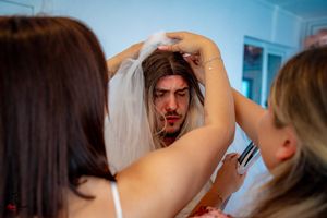 Close-up of hair styling preparation with styling tools visible.