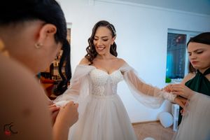 Bridesmaids in floral and teal dresses helping during wedding preparations.