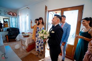 Wedding party members gathered in a bright indoor space during preparations.