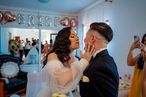 Wedding celebration scene with decorative 'BRIDE' text visible on the wall.